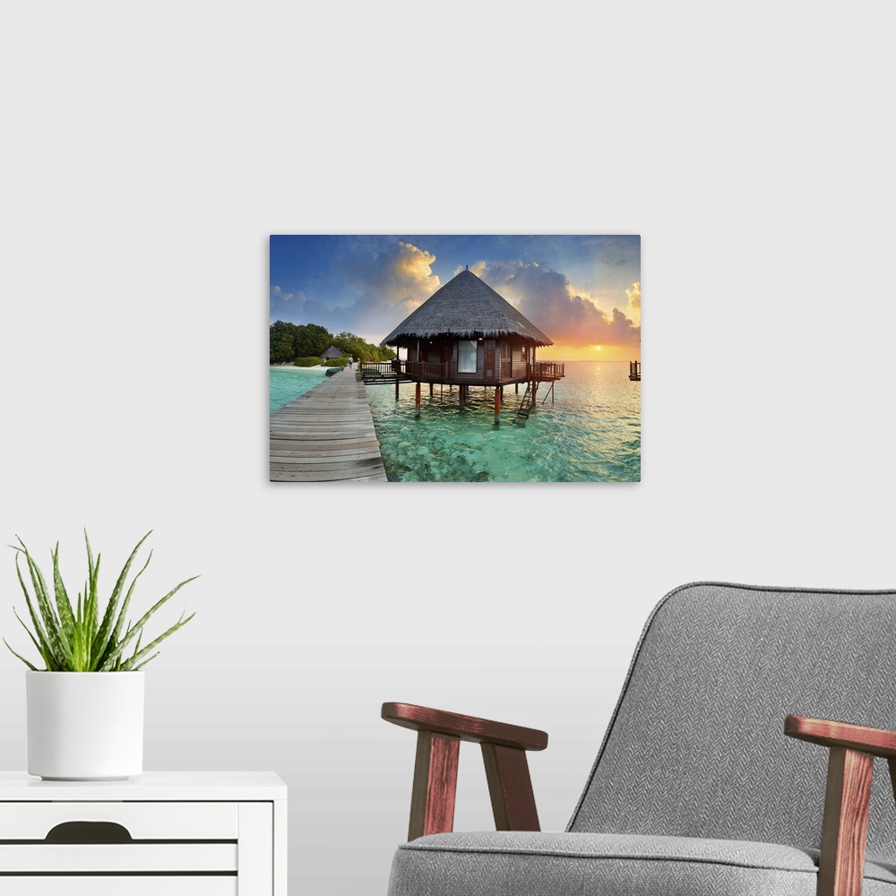 A modern room featuring Maldives, Velidhu, Ari Atoll at sunset.