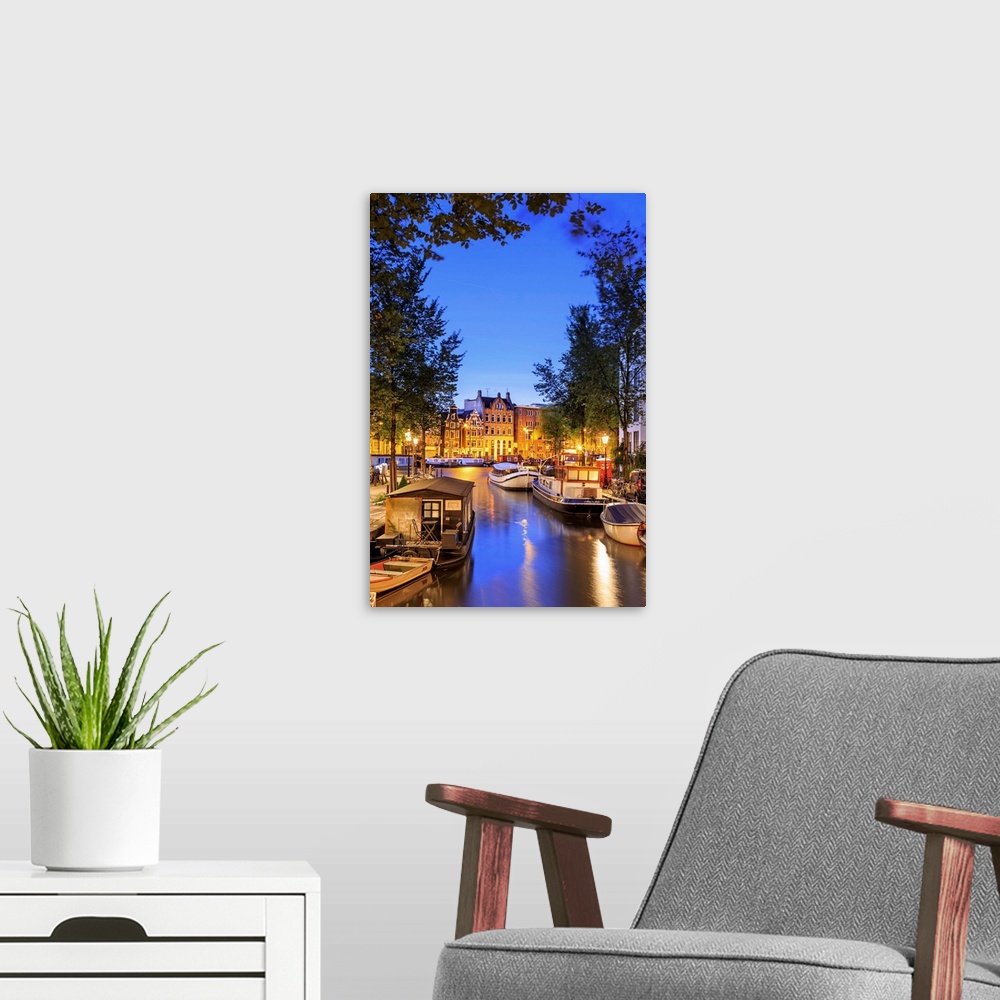 A modern room featuring Netherlands, North Holland, Benelux, Amsterdam, Groenburgwal Canal at night.
