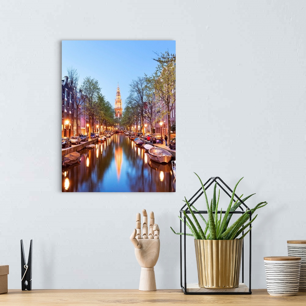 A bohemian room featuring Netherlands, North Holland, Benelux, Amsterdam, Montelbaan Tower at Oude Schans illuminated at dusk.
