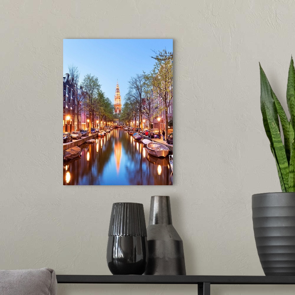 A modern room featuring Netherlands, North Holland, Benelux, Amsterdam, Montelbaan Tower at Oude Schans illuminated at dusk.