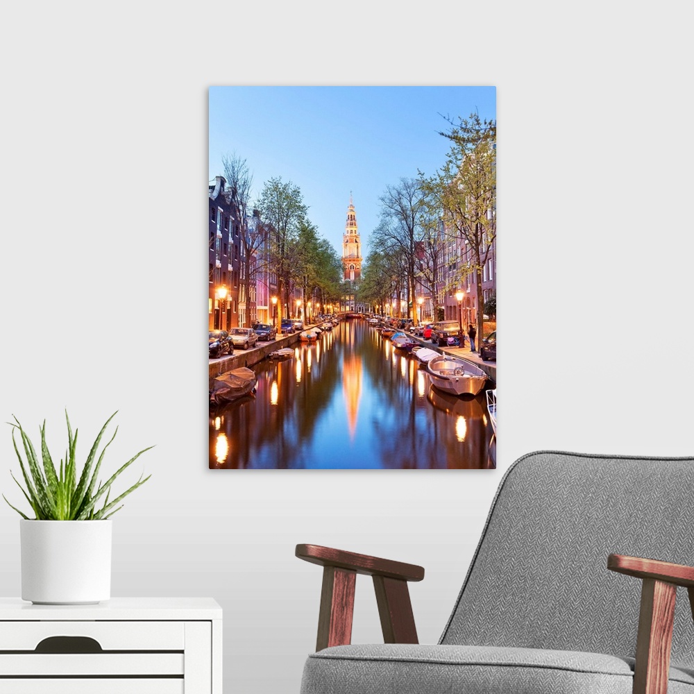 A modern room featuring Netherlands, North Holland, Benelux, Amsterdam, Montelbaan Tower at Oude Schans illuminated at dusk.