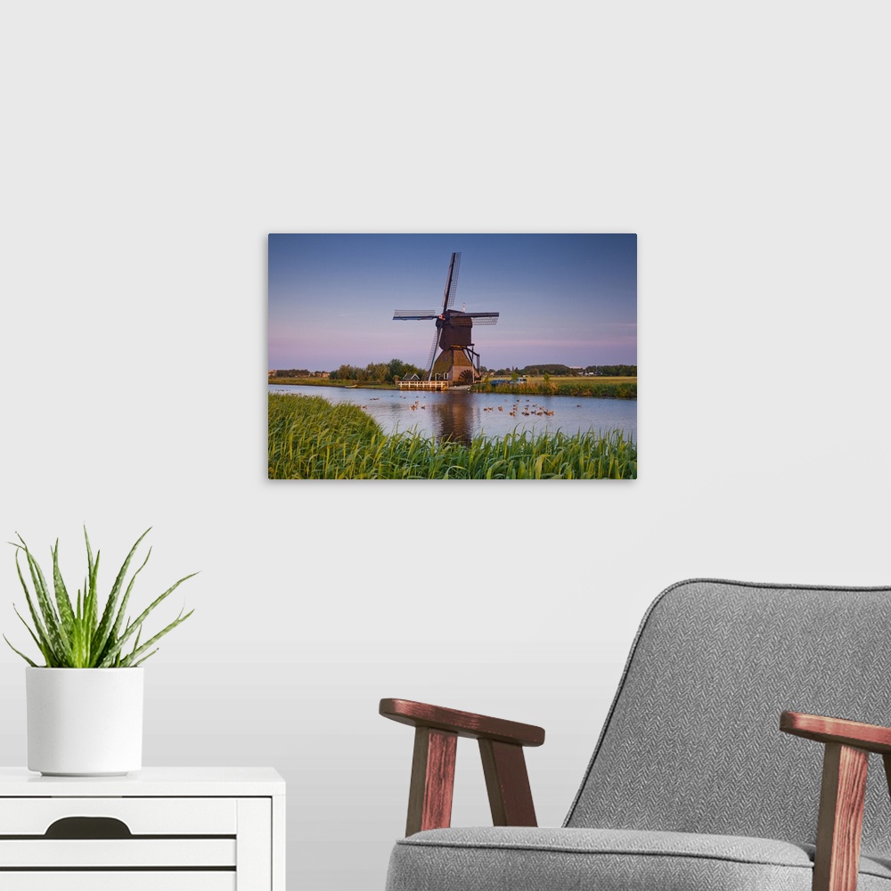 A modern room featuring Netherlands, South Holland, Benelux, Kinderdijk, Windmill, evening.