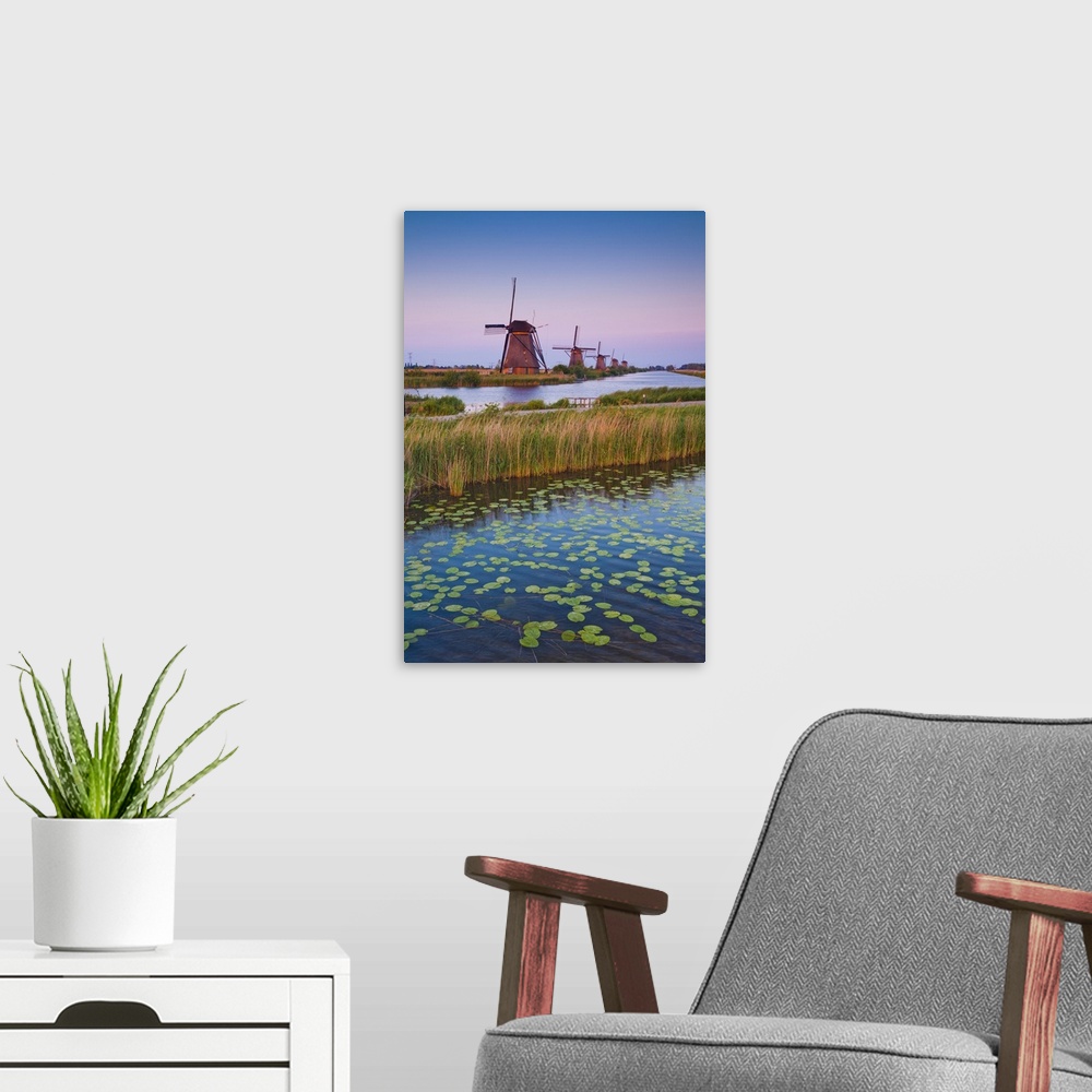 A modern room featuring Netherlands, South Holland, Benelux, Kinderdijk, Windmill, evening.
