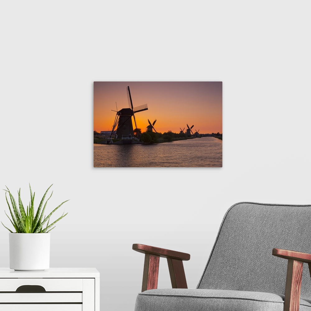 A modern room featuring Netherlands, South Holland, Benelux, Kinderdijk, Windmills at sunset.