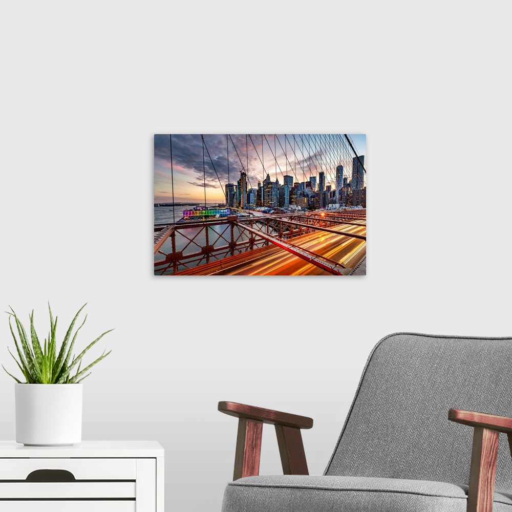 A modern room featuring New York City, Brooklyn Bridge, Lower Manhattan views seen through suspension wire..
