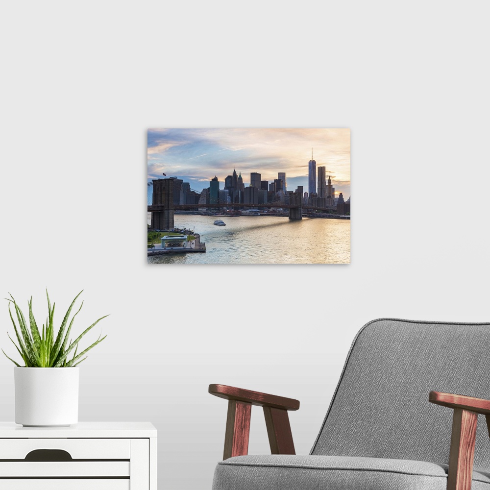A modern room featuring USA, New York City, Brooklyn, Dumbo, Brooklyn Bridge, Manhattan skyline at sunset.