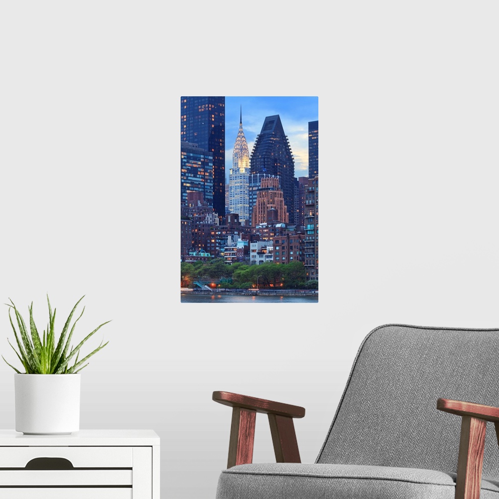 A modern room featuring USA, New York City, Manhattan, Midtown, Chrysler Building, View towards Manhattan at dusk from Ro...
