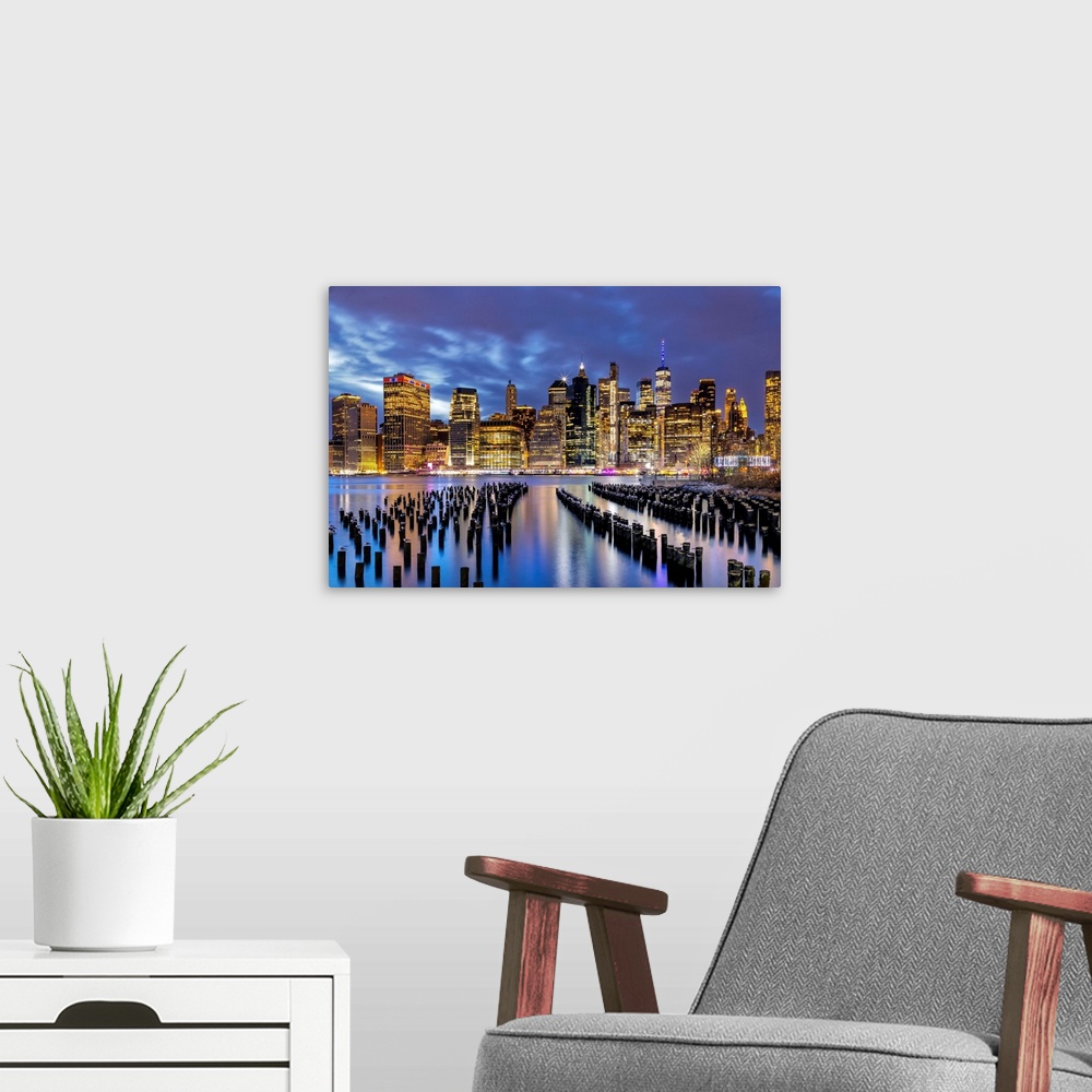 A modern room featuring New York City, downtown skyline seen from Brooklyn.