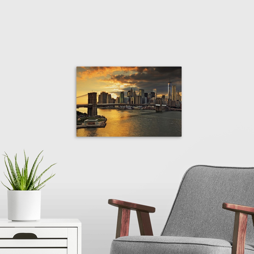 A modern room featuring USA, New York City, East River, Manhattan, Brooklyn Bridge, Downtown skyline at sunset, view from...
