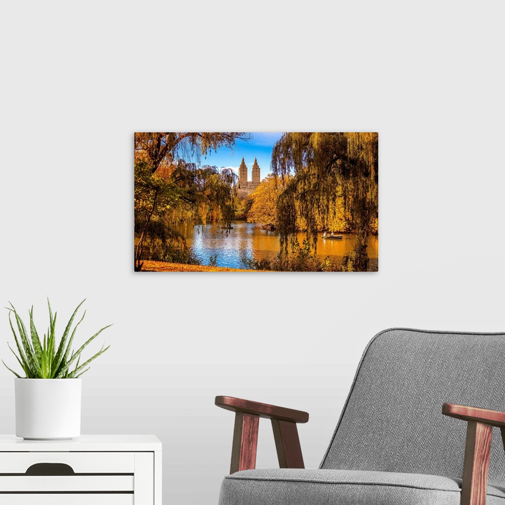 A modern room featuring USA, New York City, Manhattan, Central Park, The lake and San Remo apartment building, foliage.