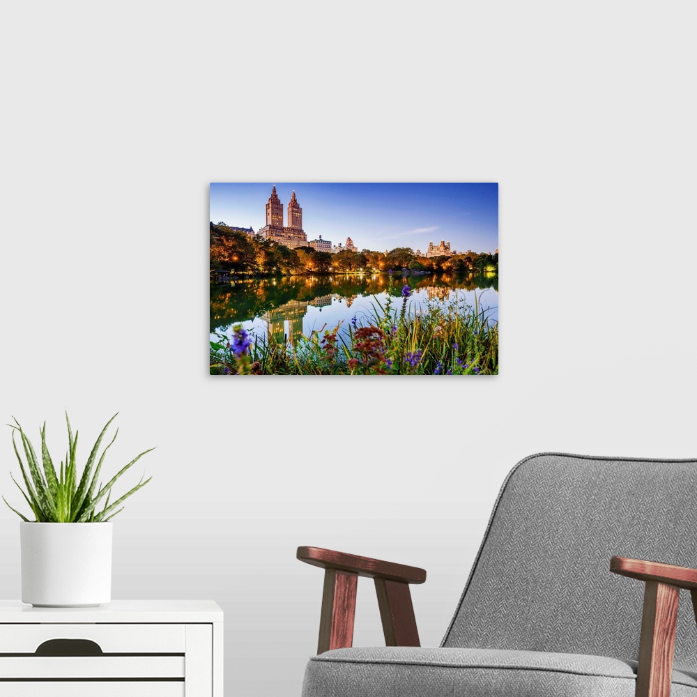 A modern room featuring USA, New York City, Manhattan, Central Park, the lake Apartment Building The San Remo, sunset.