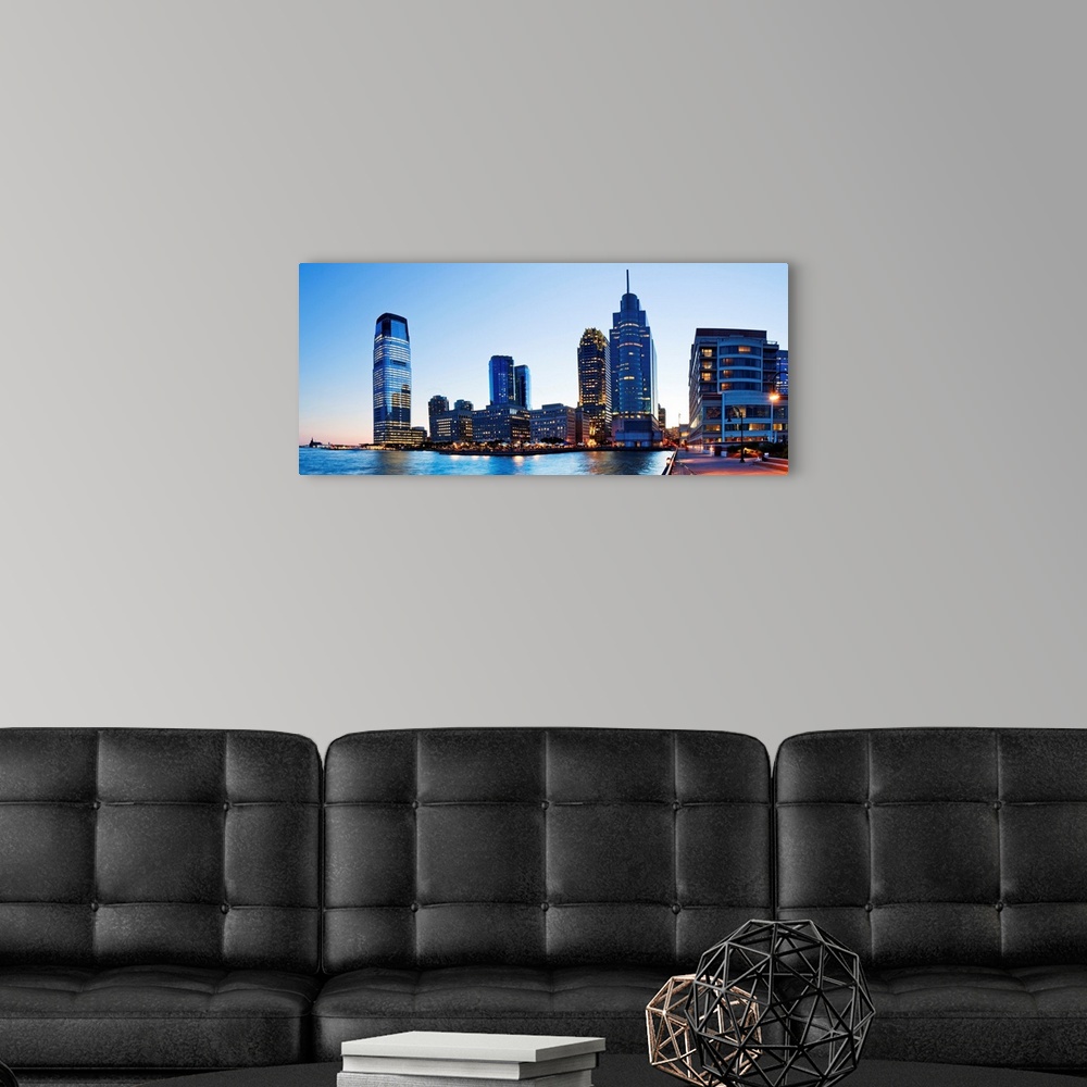 A modern room featuring USA, New York City, Manhattan, New Jersey skyline at night.