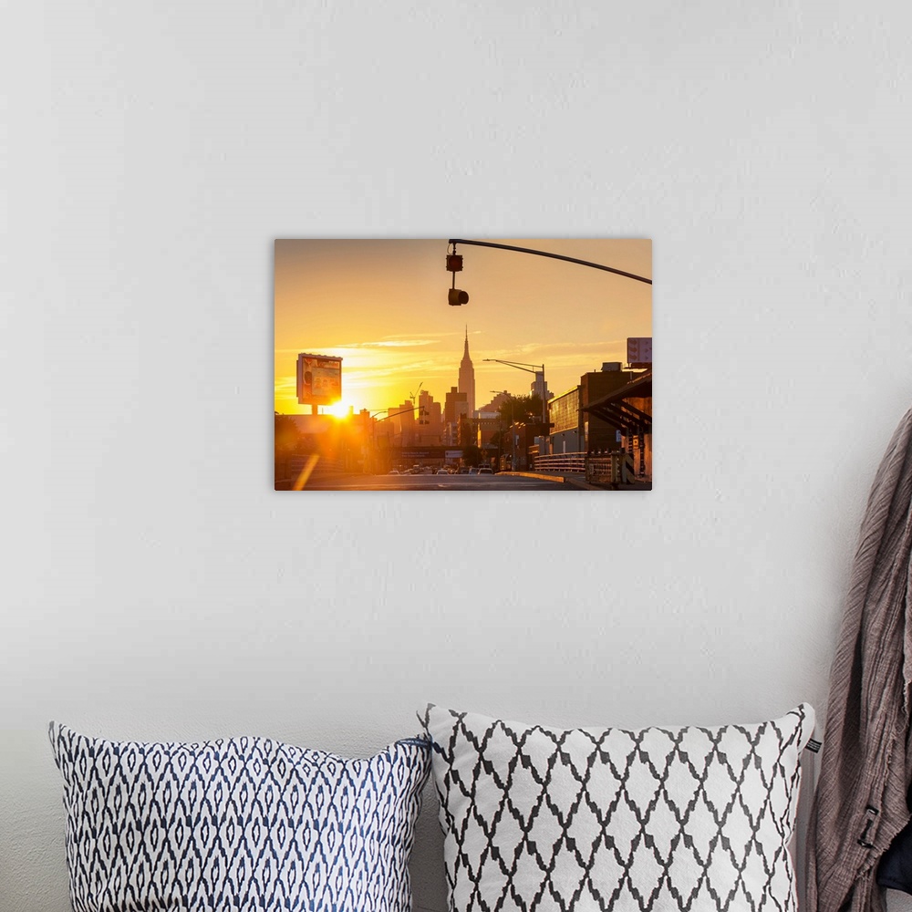 A bohemian room featuring New York, NYC, Long Island City, view of Manhattan Skyline with Empire State silhouetted, sunset..