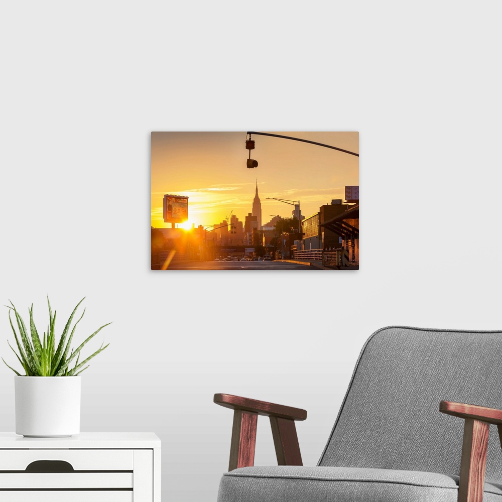 A modern room featuring New York, NYC, Long Island City, view of Manhattan Skyline with Empire State silhouetted, sunset..