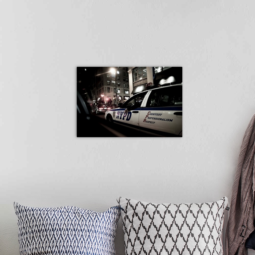 A bohemian room featuring New York State, New York City, New York Police Department car at night