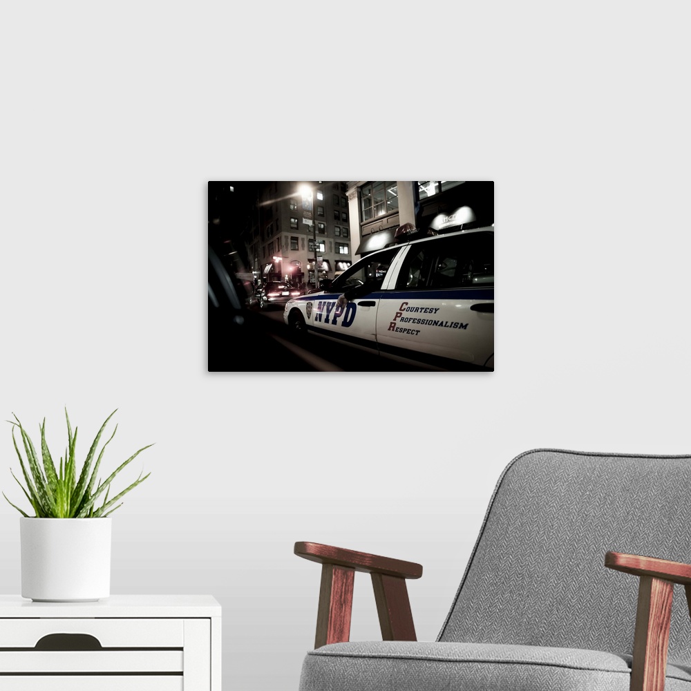 A modern room featuring New York State, New York City, New York Police Department car at night