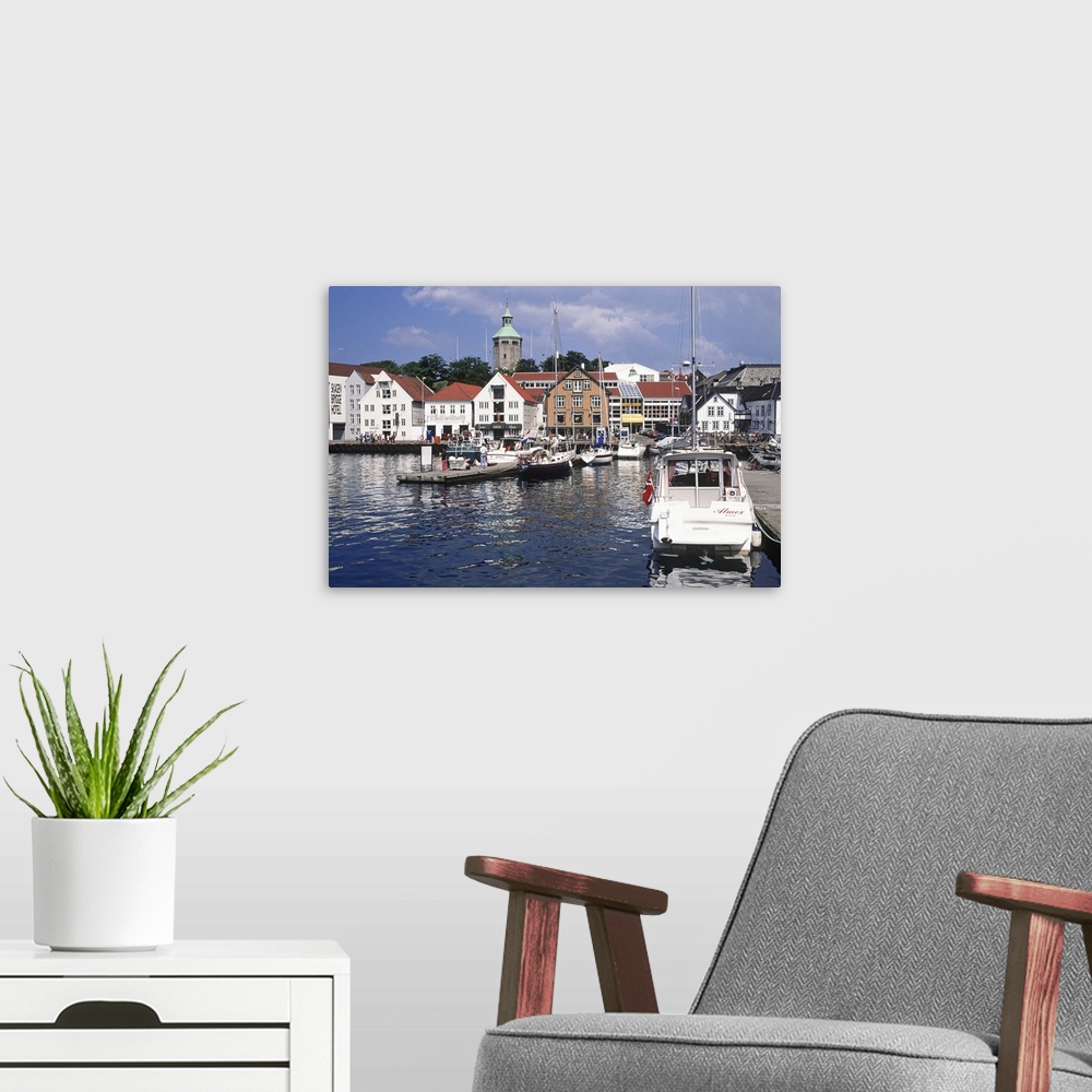 A modern room featuring Norway, Rogaland, View of the harbour with the restored old fish warehouses