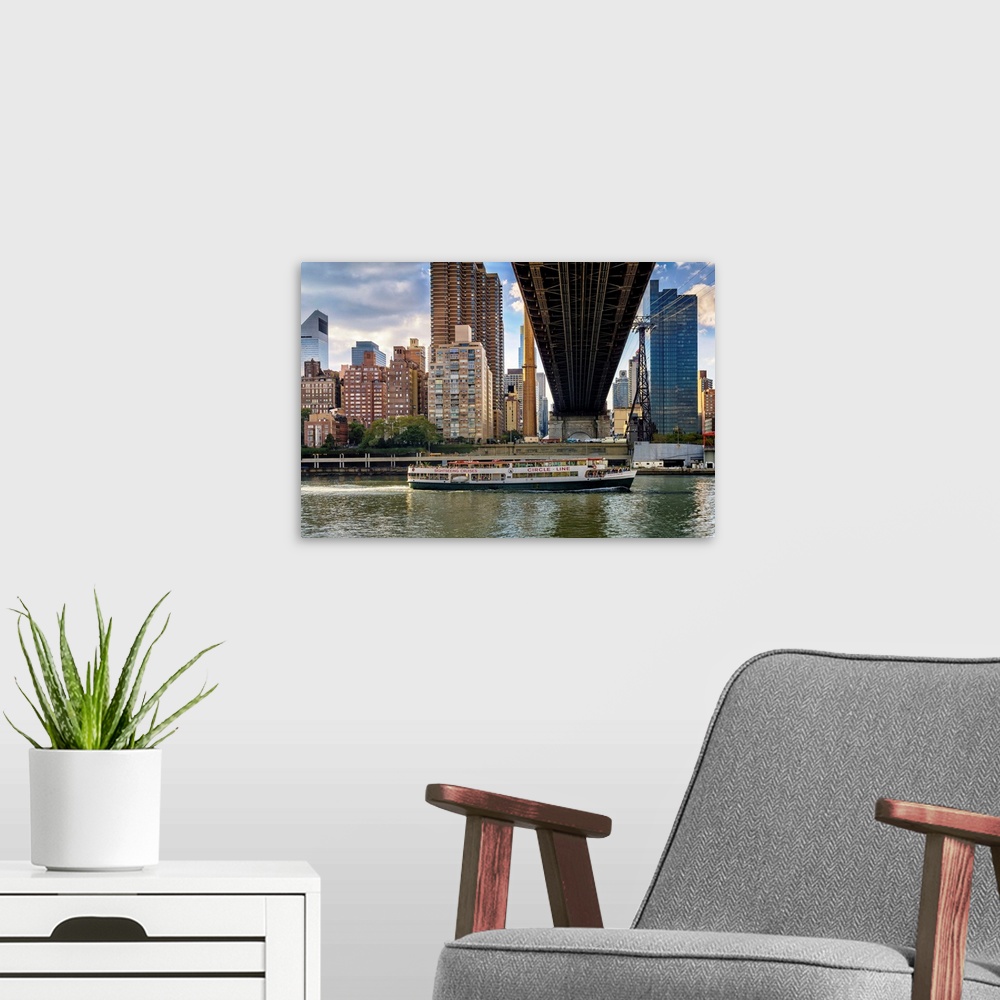 A modern room featuring New York, NYC, City skyline, Queensboro Bridge, cruise ship, viewed from Roosevelt Island.