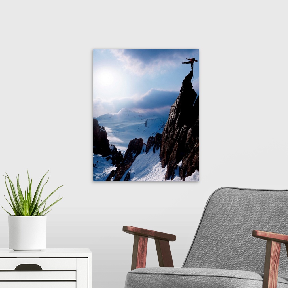 A modern room featuring Rock climber at the peak of a snow capped mountain