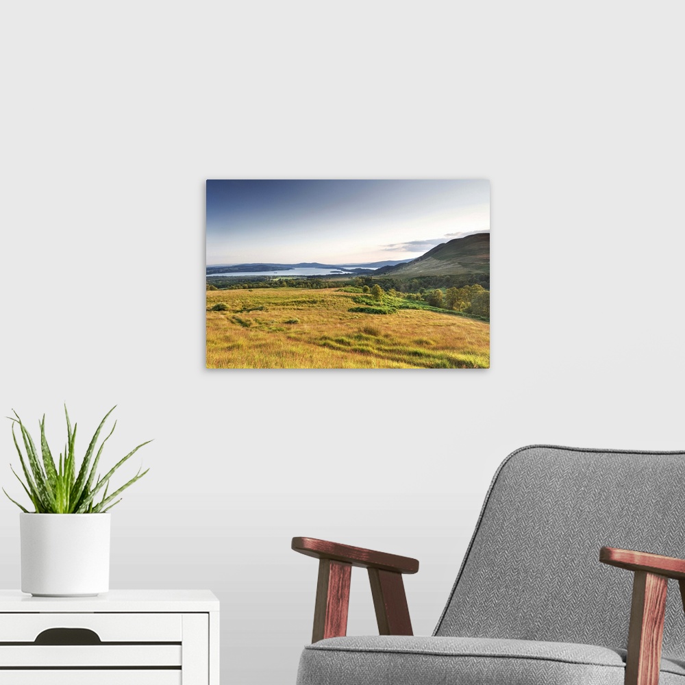 A modern room featuring UK, Scotland, Loch Lomond, Great Britain, Field with the Conic Hill in the background at dusk.