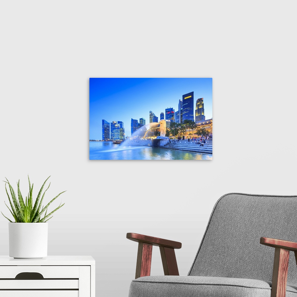 A modern room featuring Singapore, Singapore City, Merlion fountain at night.