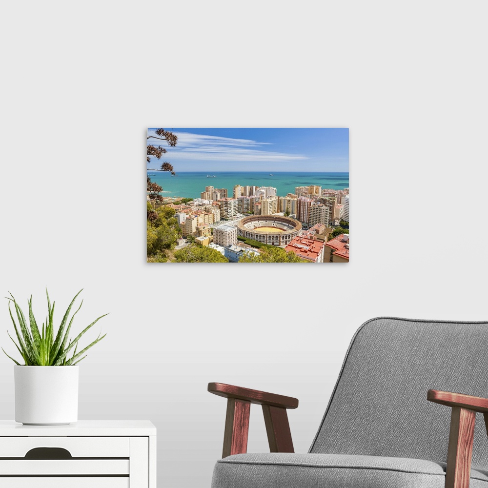 A modern room featuring Spain, Andalusia, Malaga, Malaga district, Costa del Sol, Bullring surrounded by skyscrapers, vie...