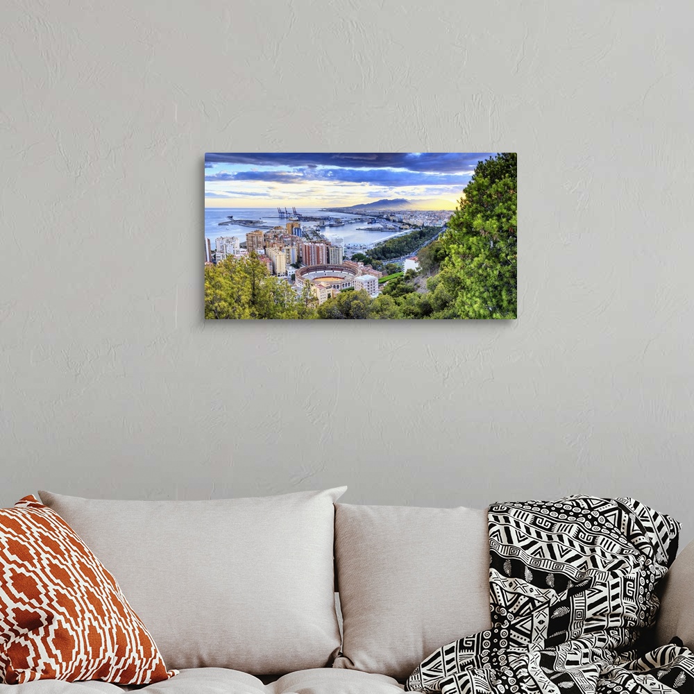 A bohemian room featuring Spain, Andalusia, Malaga district, Malaga, Cityscape with the famous bullring at sunset