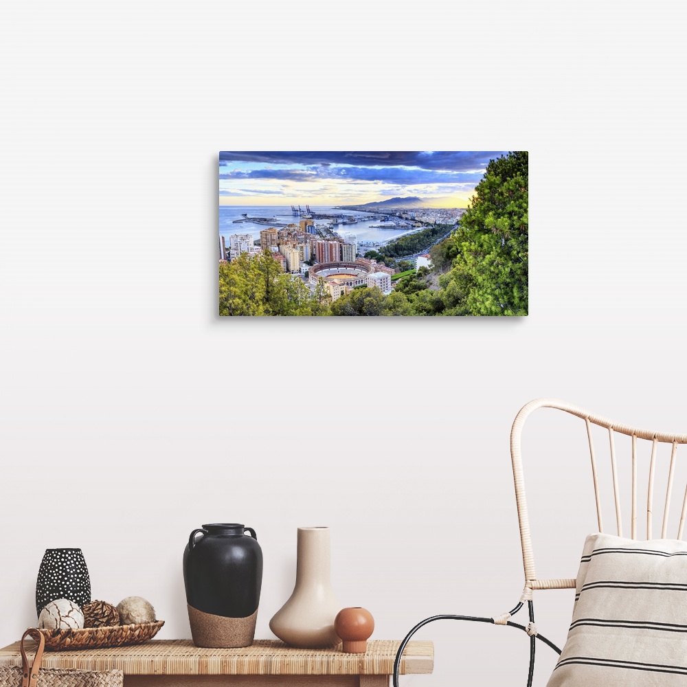 A farmhouse room featuring Spain, Andalusia, Malaga district, Malaga, Cityscape with the famous bullring at sunset