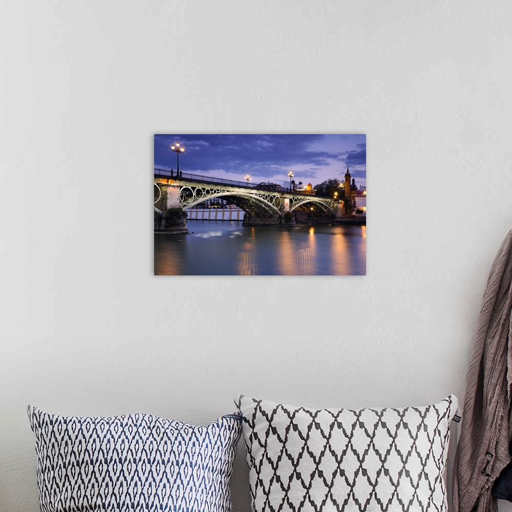 A bohemian room featuring Spain, Andalusia, Seville, Puente de Isabel II across the Rio Guadalquivir