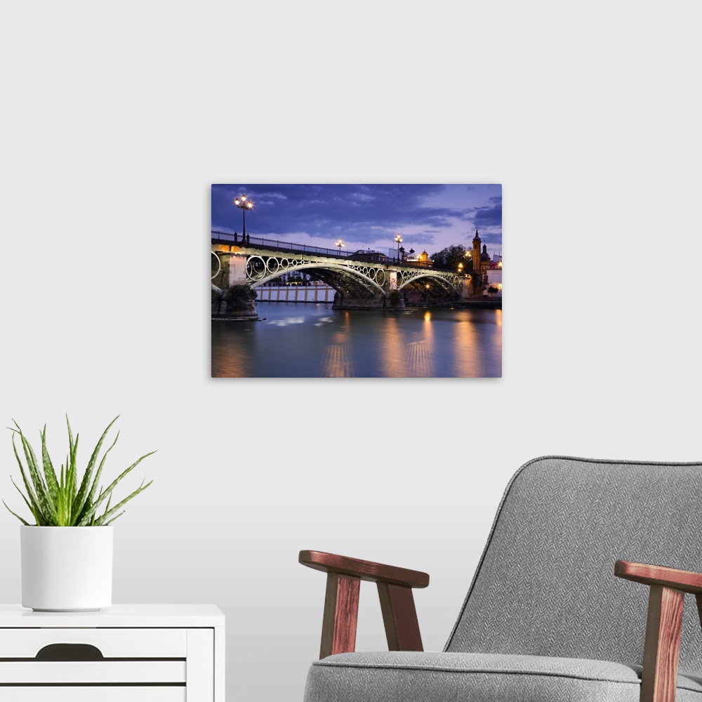 A modern room featuring Spain, Andalusia, Seville, Puente de Isabel II across the Rio Guadalquivir