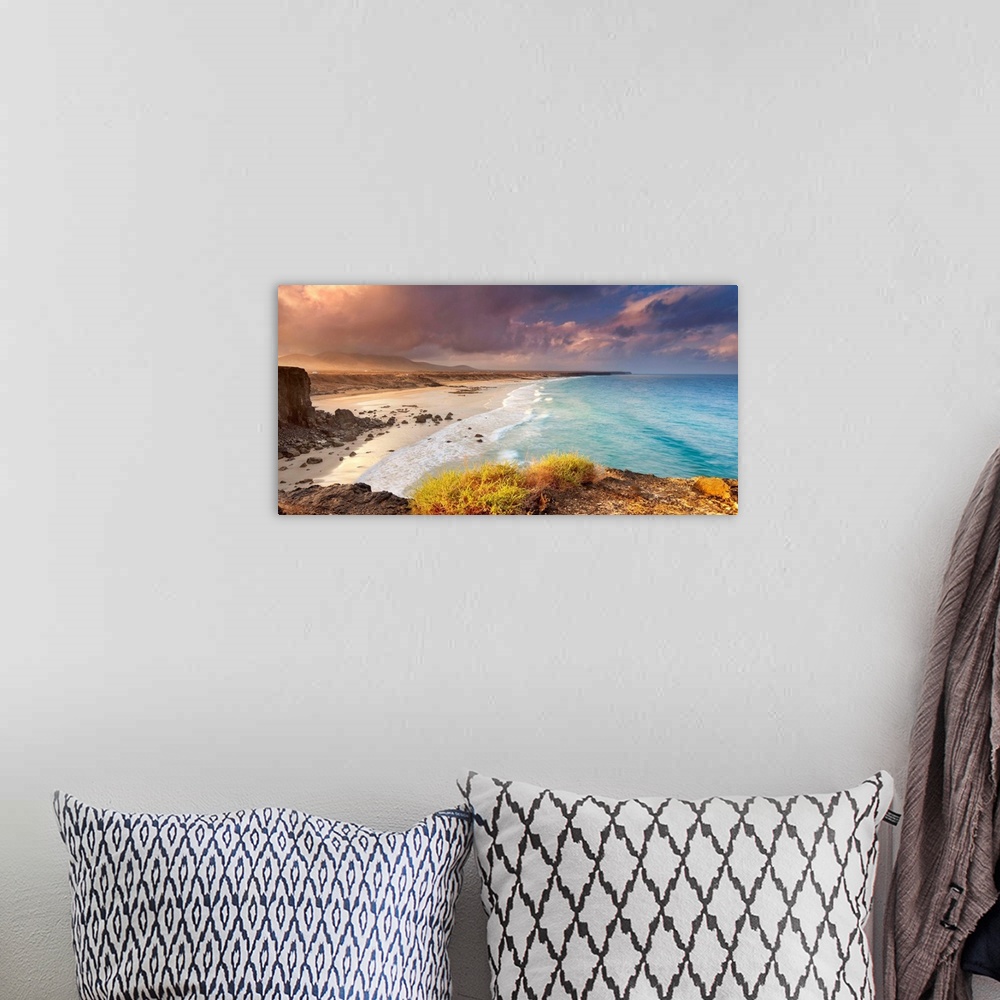 A bohemian room featuring Spain, Canary Islands, Fuerteventura, Beach and rugged coastline at dawn.