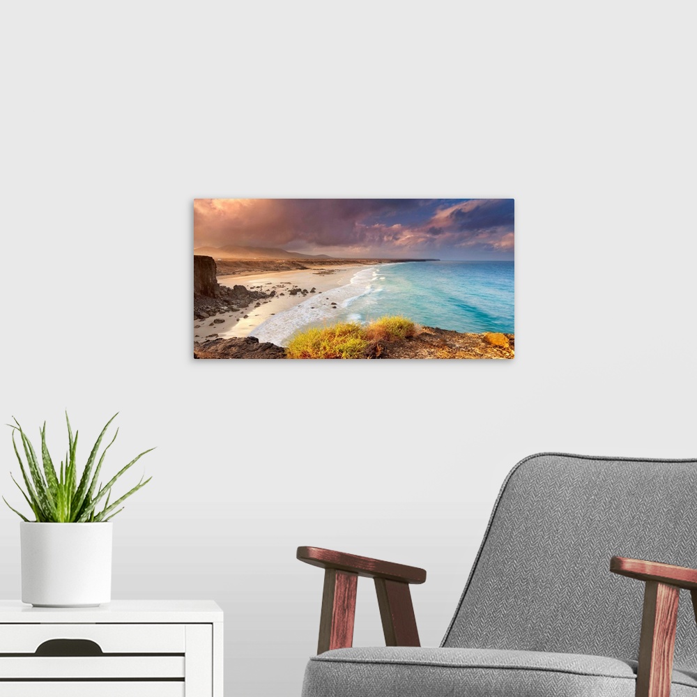 A modern room featuring Spain, Canary Islands, Fuerteventura, Beach and rugged coastline at dawn.