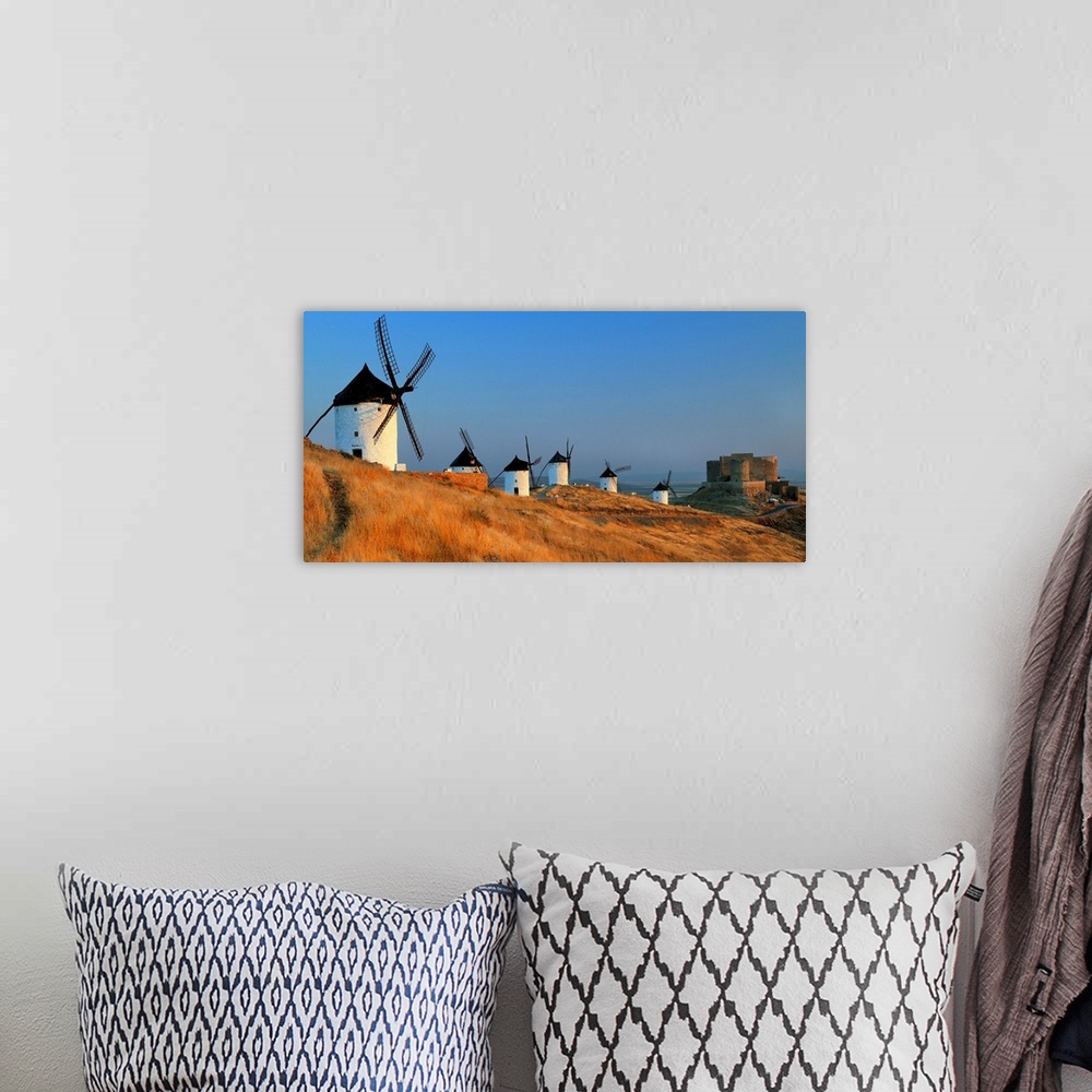 A bohemian room featuring Spain, Castilla-La Mancha, Consuegra, windmills and the castle near the village