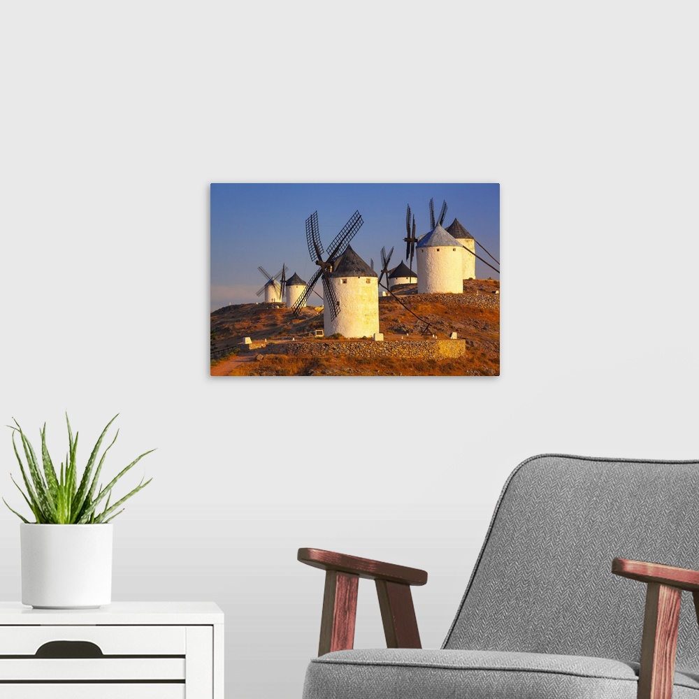 A modern room featuring Spain, Castilla-La Mancha, Consuegra, Windmills near the village, sunrise
