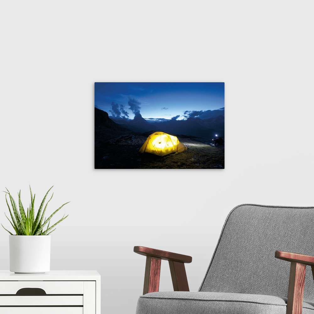 A modern room featuring Switzerland, Valais, Alps, glowing light from tent in the wilderness