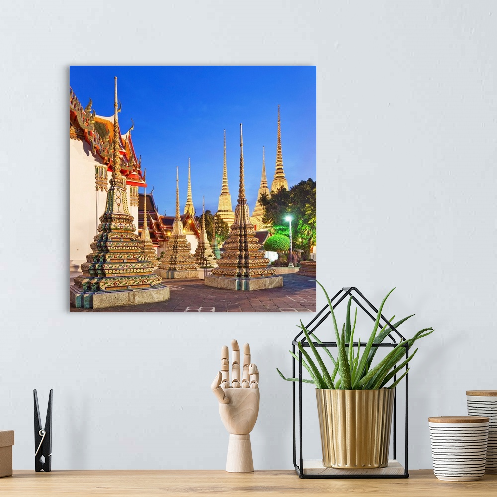 A bohemian room featuring Thailand, Central Thailand, Bangkok, Wat Pho, Temple of the Reclining Buddha illuminated at dusk.