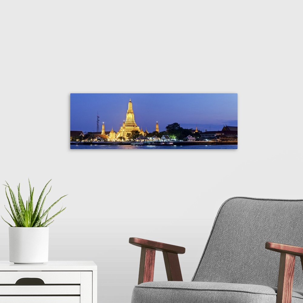 A modern room featuring Thailand, Thailand Central, Bangkok, Wat Arun or Temple of Dawn illuminated at night.