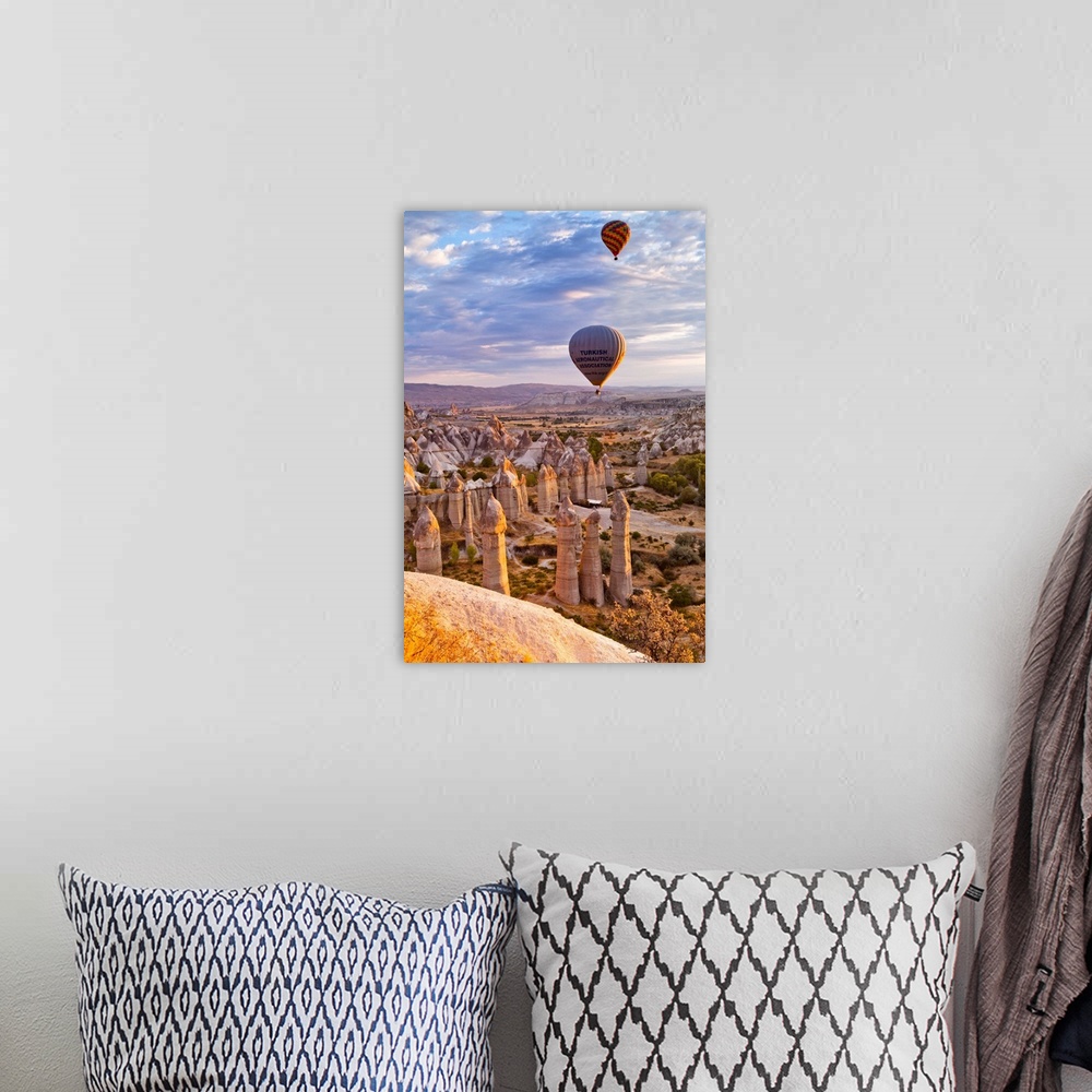 A bohemian room featuring Turkey, Central Anatolia, Cappadocia, Goreme, Hot air balloons over the Honey Valley at sunrise.