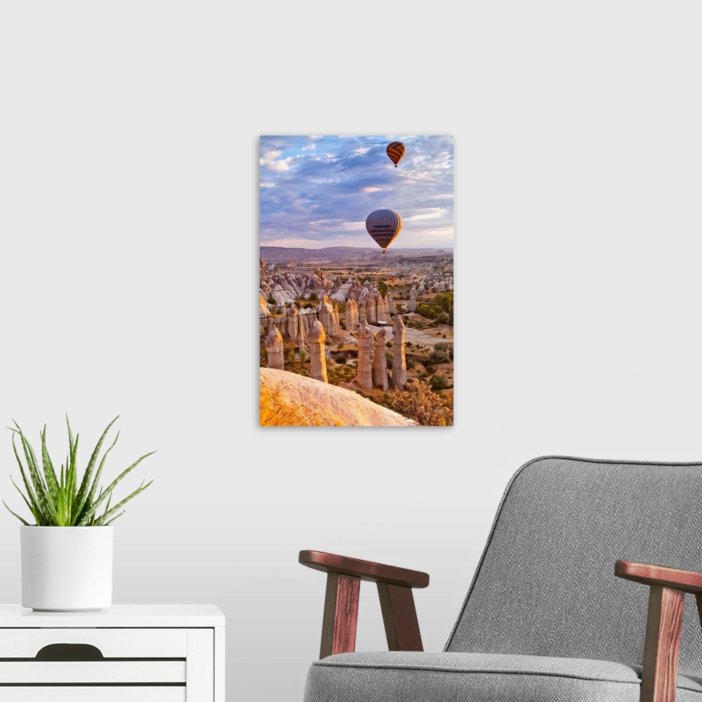 A modern room featuring Turkey, Central Anatolia, Cappadocia, Goreme, Hot air balloons over the Honey Valley at sunrise.