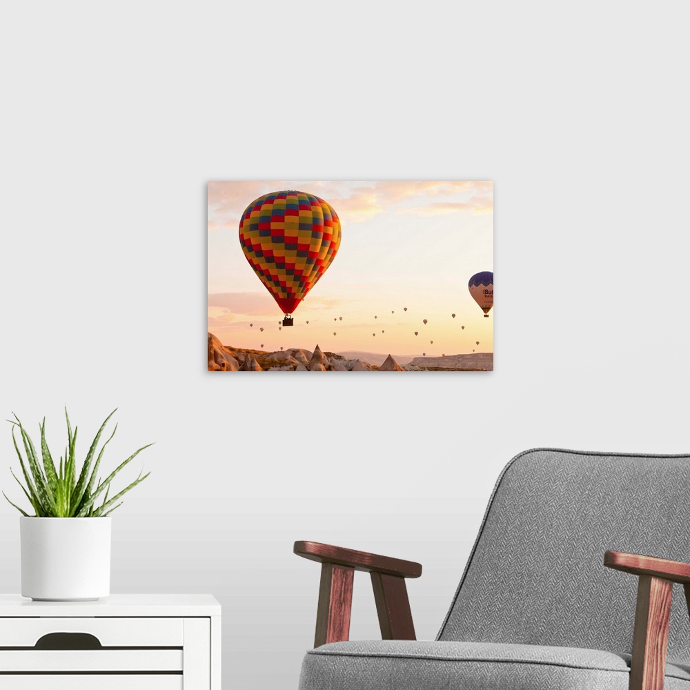 A modern room featuring Turkey, Central Anatolia, Cappadocia, Hot air balloons at sunset.