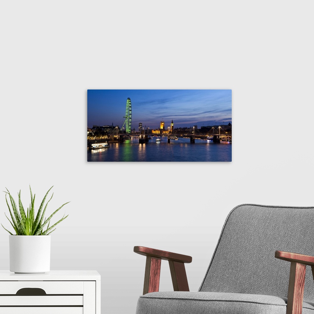 A modern room featuring UK, London, London Eye and Westminster Palace skyline at dusk