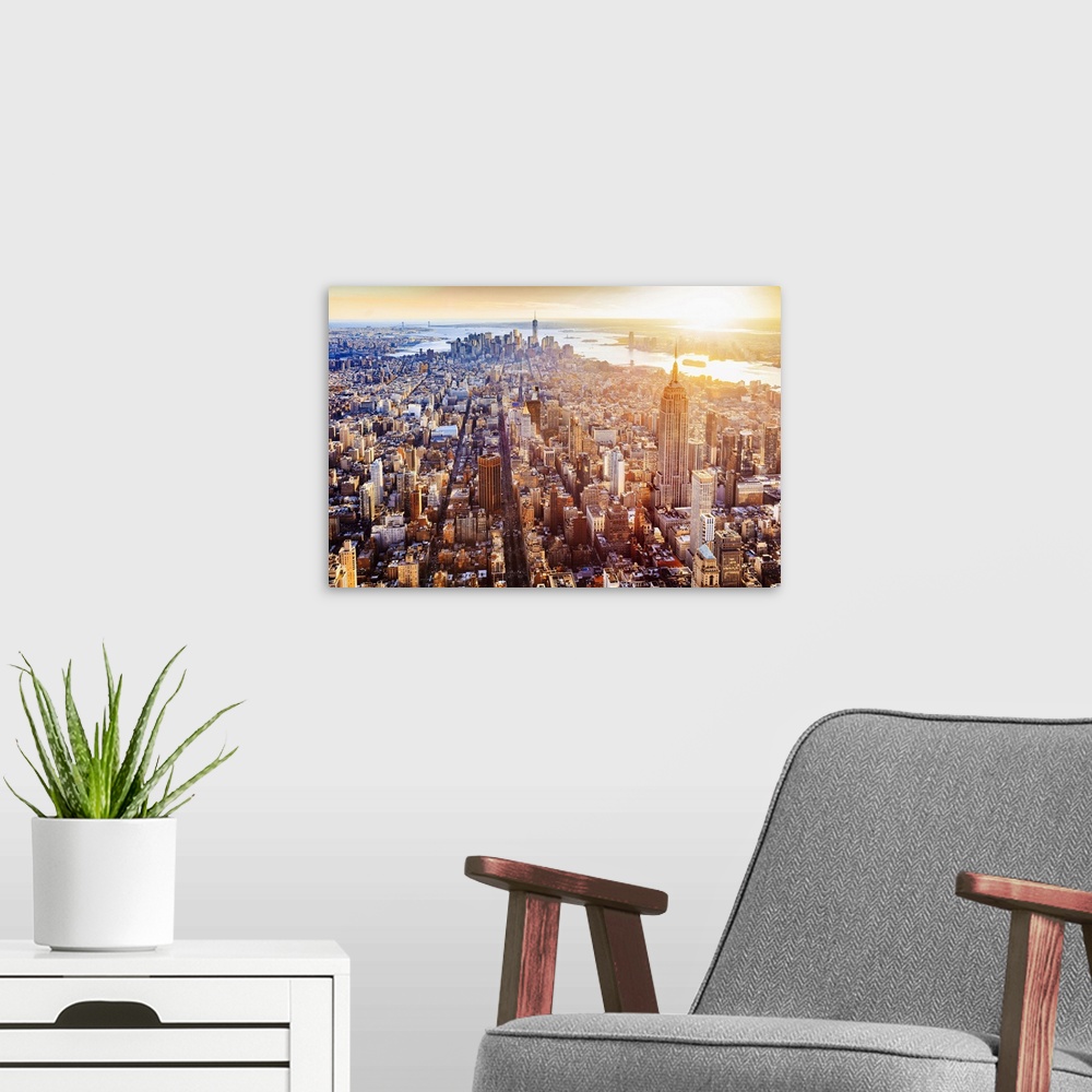A modern room featuring USA, New York City, Aerial view towards One World Trade Center and Hudson river at sunset.