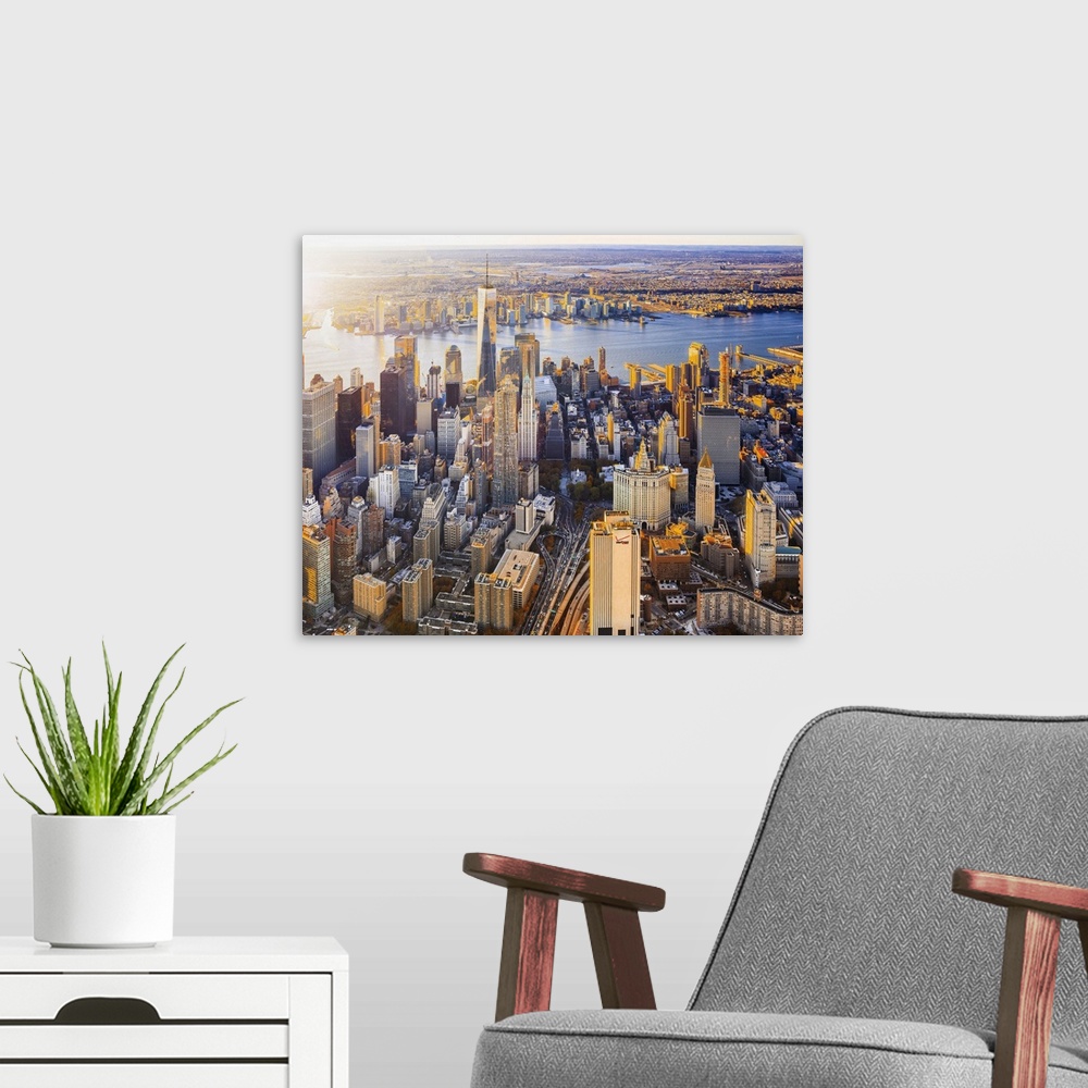 A modern room featuring USA, New York City, Lower Manhattan, Aerial view towards One World Trade Center at sunset.