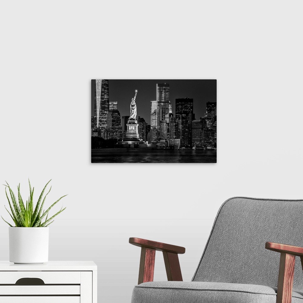 A modern room featuring USA, New York City, Lower Manhattan, Lower Manhattan skyline and Statue of Liberty at night.