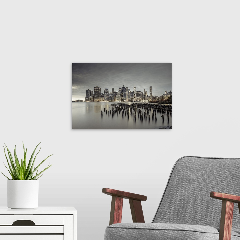 A modern room featuring USA, New York City, Lower Manhattan, Downtown skyline with Freedom Tower at night, view from Broo...