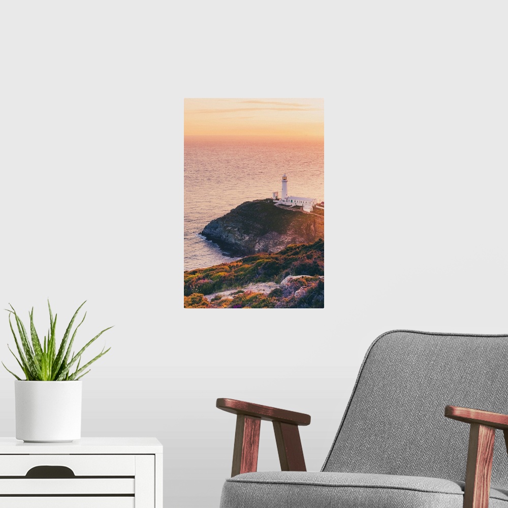 A modern room featuring Wales, Anglesey, Great Britain, British Isles, South Stack Lighthouse in North Wales at sunset on...