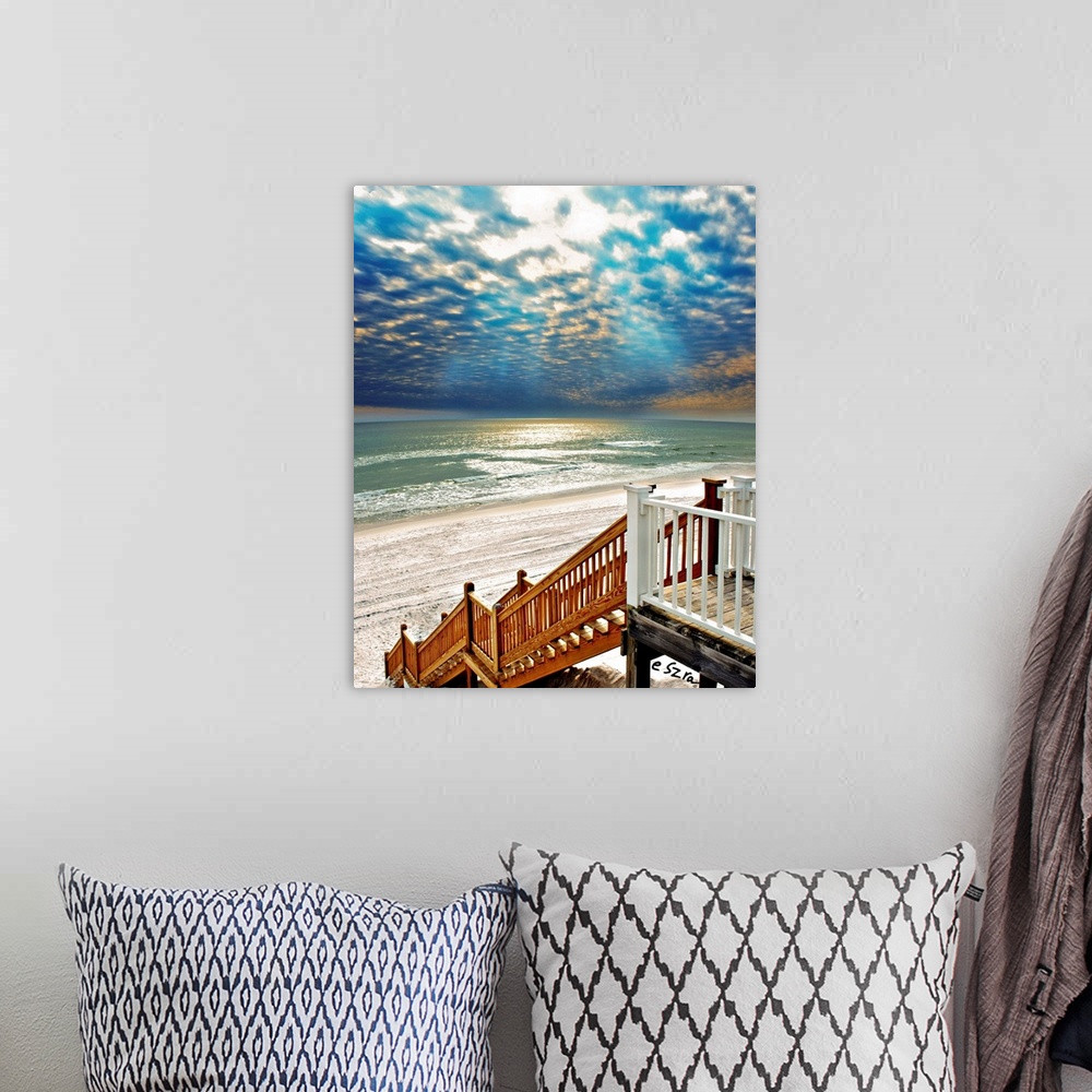 A bohemian room featuring A beach Staircase leading to a glistening sea.
