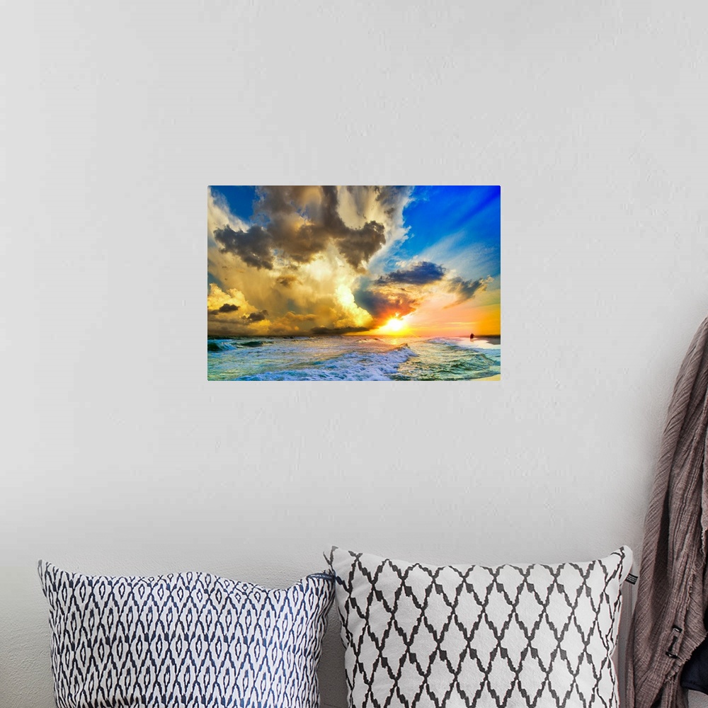 A bohemian room featuring Tall clouds before a blue sky and a sunset over a beautiful beach landscape.