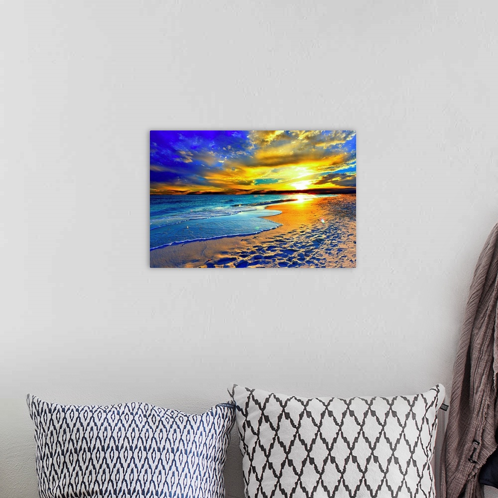 A bohemian room featuring A magnificent orange sunset over the beach and blue sea. Orange clouds fill the sky with color ov...