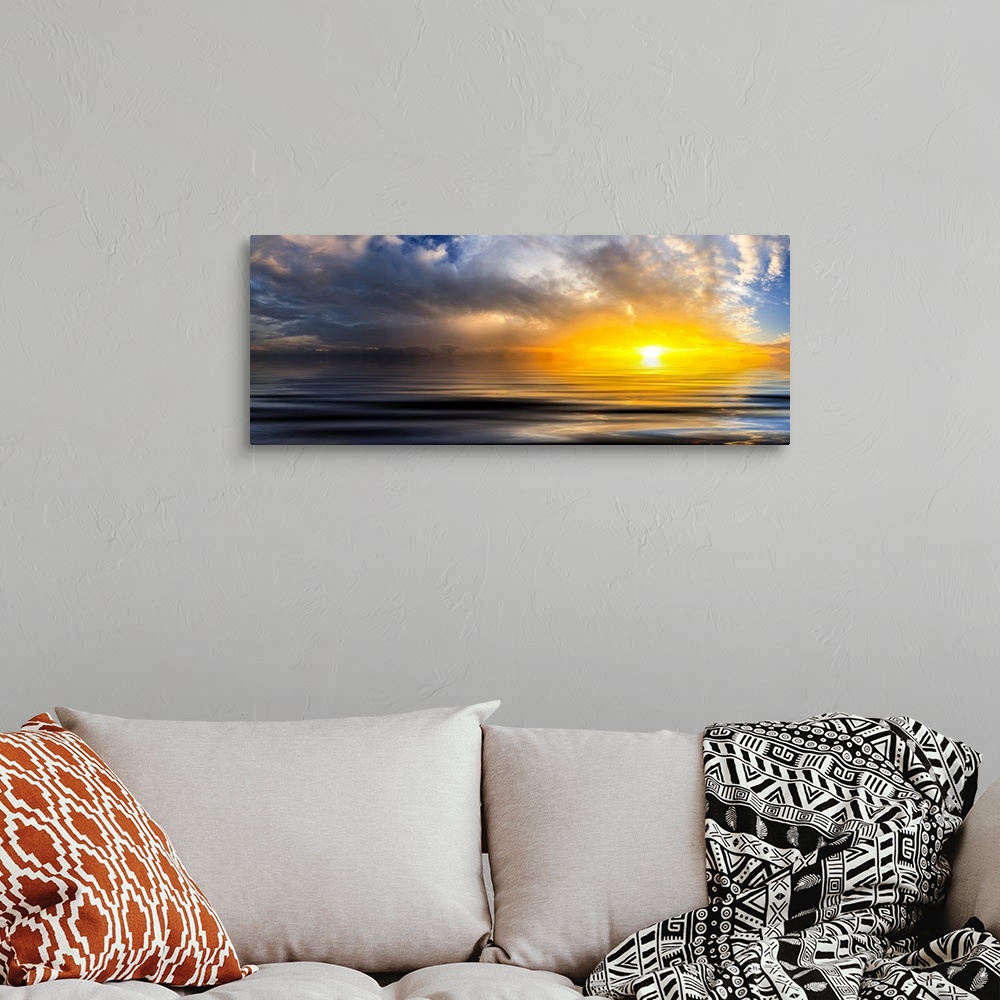 A bohemian room featuring A beautiful golden panoramic sunset reflected in the ocean waves at sunset with bright spiraling ...